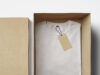 box with folded white shirt and label inside