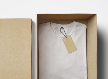 box with folded white shirt and label inside