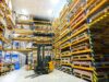 Warehouse with stacked pallets and a fork lift
